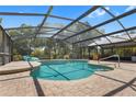 Enjoy this covered pool with brick patio, perfect for relaxing and entertaining in a private, screened-in setting at 3871 Dallas Blvd, Orlando, FL 32833