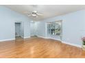Bright living room features laminate flooring, a ceiling fan, and large windows for natural light at 731 Red Coach Ave, Deltona, FL 32725