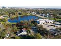 Aerial view of a property near a serene lake, showcasing its neighborhood and surrounding landscape at 1235 19Th St, Orlando, FL 32805