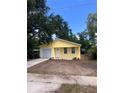 Charming yellow home with a new garage door, freshly painted exterior and landscaping at 1235 19Th St, Orlando, FL 32805