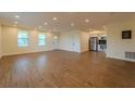 Spacious living area with hardwood floors and open concept design leading into the kitchen at 1235 19Th St, Orlando, FL 32805
