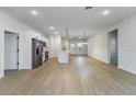 Spacious open-concept living area boasts modern light fixtures, wood floors, and a stylish kitchen at 14962 Sw 39Th Cir, Ocala, FL 34473
