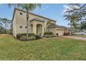 Two-story house with a large front yard and palm trees at 256 Yellow Snapdragon Dr, Davenport, FL 33837