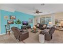 Relaxing living room with leather couches and a teal accent wall at 256 Yellow Snapdragon Dr, Davenport, FL 33837