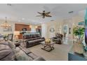 Spacious living room with brown leather furniture and a ceiling fan at 256 Yellow Snapdragon Dr, Davenport, FL 33837