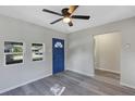 Living room with gray walls, gray flooring, and blue door at 805 Willow Ave, Sanford, FL 32771