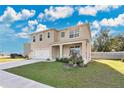 Two story house with landscaping and a driveway at 11237 Amber Ridge Dr, Zellwood, FL 32798