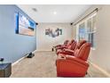 Home theater room with a large screen TV and red leather seating at 11237 Amber Ridge Dr, Zellwood, FL 32798