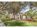 House with a nicely landscaped yard at 1610 Conway Isle Cir, Belle Isle, FL 32809