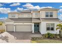 Two-story house with solar panels, three-car garage, and landscaped yard at 4360 Sunset Preserve Blvd, Orlando, FL 32820
