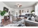 Spacious living room with hardwood floors, sectional sofa, and large TV at 4973 Pall Mall W St, Kissimmee, FL 34758