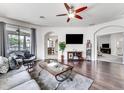 Spacious living room with hardwood floors, sectional sofa, and large TV at 4973 Pall Mall W St, Kissimmee, FL 34758