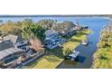 Stunning waterfront home with a private pool, boat dock, and lush landscaping at 6025 Lady Bet Dr, Orlando, FL 32819
