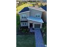 Contemporary two-story house with gray siding and a brick facade at 8900 Takeaway Way, Davenport, FL 33896