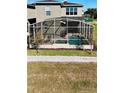 Screened-in pool and spa with a gray stone wall at 8900 Takeaway Way, Davenport, FL 33896