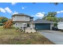 Home with circular design, detached garage, and landscaped patio area at 1399 Old Mount Dora Rd, Eustis, FL 32726