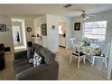 Cozy living room with a grey sofa, ceiling fan and a dining table for four, offering a comfortable and inviting space at 1456 N Page Dr, Deltona, FL 32725