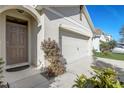 Front entry and garage with landscaping at 273 St Georges Cir, Eagle Lake, FL 33839