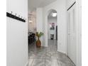 Bright entryway with tile flooring, coat rack, and view into dining area at 2821 Almaton Loop # 101, Kissimmee, FL 34747