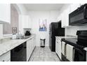 Modern kitchen with white cabinets and black appliances at 2821 Almaton Loop # 101, Kissimmee, FL 34747