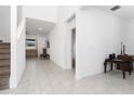 Bright hallway with tiled floors and views of living and Gathering rooms at 285 Miro Dr, Davenport, FL 33837