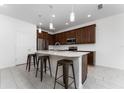 Modern kitchen with dark brown cabinets, white countertops, and stainless steel appliances at 285 Miro Dr, Davenport, FL 33837