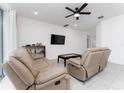 Living room featuring two reclining sofas and a coffee table at 285 Miro Dr, Davenport, FL 33837