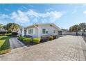 Gray house with manicured lawn and paver driveway at 604 Endsley Ave, Altamonte Springs, FL 32701