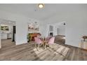Bright dining room with glass table and pink chairs at 6424 Sleepy Hollow Dr, Orlando, FL 32810