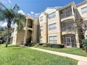 Exterior view of condo building showcasing landscaping and walkways at 8103 Coconut Palm Way # 105, Kissimmee, FL 34747
