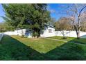 Side yard of the house with lush green grass at 1202 Dewey Ave, Orlando, FL 32808