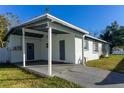 Covered patio and carport add to this home's appeal at 1202 Dewey Ave, Orlando, FL 32808