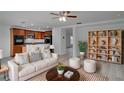 Comfortable living area with an open floor plan, connecting the kitchen and showcasing stylish decor at 12755 Oulton Cir, Orlando, FL 32832