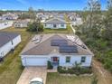 One-story house with solar panels, driveway and neighborhood view at 208 Goldenrod Ln, Kissimmee, FL 34759