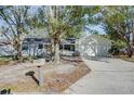 Newly painted single story home with mature landscaping and a driveway at 209 Meadow Hills Dr, Sanford, FL 32773