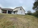 Back of house showing a large yard and patio area at 3603 Kariba Ct, Kissimmee, FL 34746