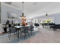 Open-concept living room with dining area and modern furniture at 5810 Penney Ln, The Villages, FL 32163