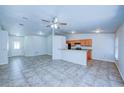Open-concept living room, kitchen, and breakfast bar with tile floors at 637 Twin Lake Ave, Deltona, FL 32738