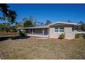 Side view of a renovated single story home with a spacious yard at 1639 Hialeah St, Orlando, FL 32808
