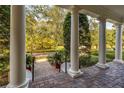 Covered porch with columns overlooking a tree-lined street at 4424 New Broad St, Orlando, FL 32814