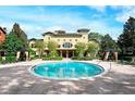 Community pool with building and landscaping in background at 1341 Arbor Vista Loop # 113, Lake Mary, FL 32746