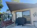 Covered patio with a grill and seating area at 1641 Lake Marion Dr, Apopka, FL 32712