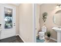 Small half bathroom with a single sink, toilet, and decorative accents at 2714 Stargrass Cir, Clermont, FL 34715