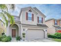 Two-story house with neutral siding, two-car garage, and landscaping at 2746 Stanwood Dr, Kissimmee, FL 34743
