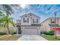 Two-story house with neutral siding, two-car garage, and landscaping at 2746 Stanwood Dr, Kissimmee, FL 34743
