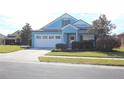 Charming one-story home with a white garage door and manicured lawn at 515 Haywood Ln, Lake Alfred, FL 33850
