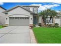 Two-story house with gray siding, landscaping, and a two-car garage at 10832 Arbor View Blvd, Orlando, FL 32825