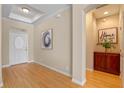 Bright and airy entryway with hardwood floors and a decorative accent wall at 1592 Lincolnshire Drive, Deland, FL 32724