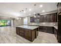 Spacious kitchen featuring dark wood cabinets and an island at 1722 Farmstead Ln, Oviedo, FL 32765