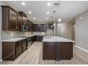 Modern kitchen with dark wood cabinets and a large island at 1722 Farmstead Ln, Oviedo, FL 32765